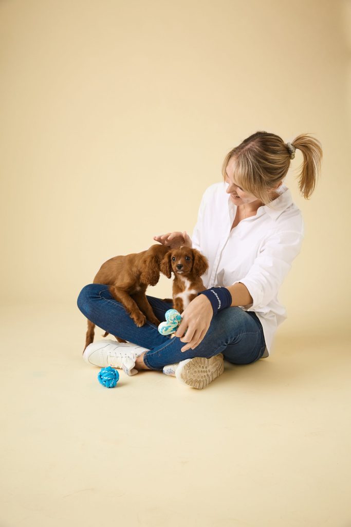 Woman carrying 2 brown dogs